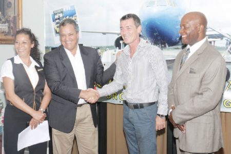 Roraima Airways’ Chief Executive Officer Gerry Gouveia and Insel Air’s Chief Commercial Officer Jurgen Lippinkhof shake after the signing of the ground handling contract between the two companies yesterday. With them are Roraima Airways’ Debra Gouveia and Patrick Triumph. Roraima Airways is the General Sales Agent for Insel Air, which is entering the Guyana market.  (Photo by Arian Browne)