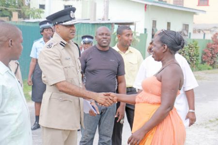 A new start? Commissioner of Police Seelall Persaud shakes the hand of an Albouystown resident before the launch of the Guyana Police Force’s “Project Impact Albouystown” yesterday afternoon. The new project will see the police force partnering with community organisations in a bid to make the community safe. (Photo by Arian Browne)