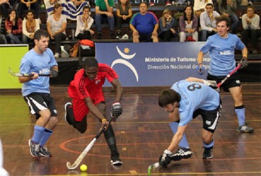 Guyana’s Jamarj Assanah being challenged by Uruguay’s German Asperger during the team’s group matchup on Wednesday. 