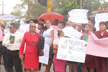 Yvonne Pearson (second, left), advisor at the Amerindian Affairs Ministry. Pearson had brought a dozen Amerindian youths to protest the budget cut on Thursday.  