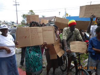 Residents outside the New Amsterdam Central Police Station yesterday protesting the shooting death of Errol Lindo. 