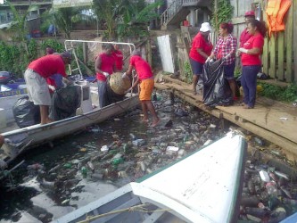 The clean-up of a section of the Port Kaituma River in full swing. A total of 730 bags of garbage were eventually collected.