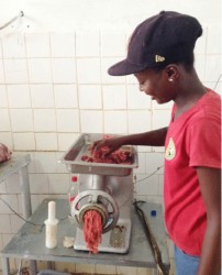 Dedeen Pluck, a worker at the Rising Sun beef farm, showing  how minced meat is made