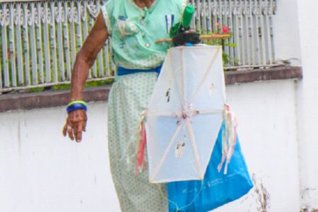 Ready for Easter! Granny strolling along Main Street in the city yesterday, kite in hand. (Photo by Arian Browne)