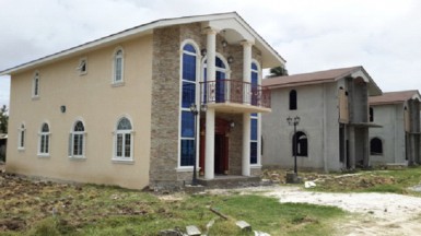 These three houses have recently undergone renovations after being constructed and seemingly left alone for some time. The site has two large washed out signboards advertising the Leonora Mall and Hollywood Gardens development projects.