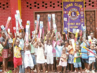 Children of Leopold Street rejoice as they hold their kites in the air 