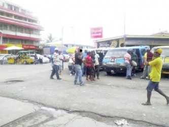 This photo shows touts harassing passengers.