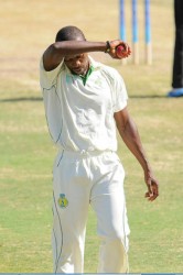 HAT TRICK HERO! Kenroy Peters wipes the sweat off his brow as he goes back to his mark.Peters yesterday became only the second Windward Islands bowler to take a hat trick in the WICB regional competition. His current coach Ian Allen was the first. (Photo courtesy of WICB media) 