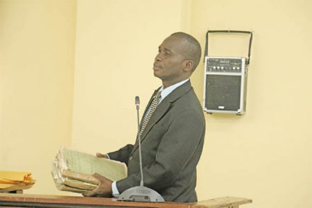 Crime Chief Senior Superintendent Leslie James with some of the file pertaining to the death of Dr. Walter Rodney which he brought before the commission yesterday. A total of six files, three each from the Special Branch and the Criminal Investigations Department (CID) were accepted as evidence.