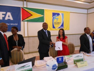 GFF President Christopher Matthias displaying the signed the four year kit contract along with Forward Sports International Incorporated Marketing and Sales Representative Juliet Osbourne.  