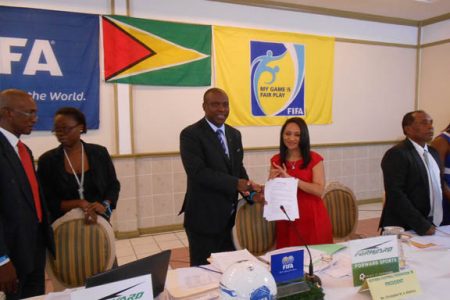 GFF President Christopher Matthias displaying the signed the four year kit contract along with Forward Sports International Incorporated Marketing and Sales Representative Juliet Osbourne.
