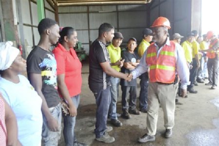 Meeting Barama workers: Prime Minister Samuel Hinds (right) greeting employees of Barama Company Limited when he visited over the weekend. (GINA photo)
