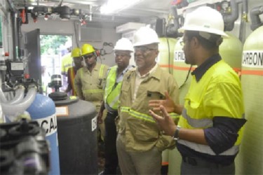 Prime Minister Samuel Hinds (second from right) touring the operations plant at Aurora Gold Mines. (GINA photo) 