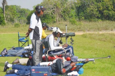 National captain Mahendra Persaud (standing) oversees team training at the Timehri ranges Sunday. 