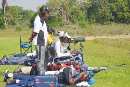 National captain Mahendra Persaud (standing) oversees team training at the Timehri ranges Sunday.