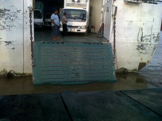 The ramp of the MV Kanawan in the water at Supenaam. In the foreground is the tarpaulin of the truck that plunged overboard.