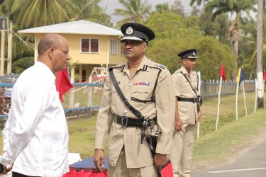 New Acting Police Commissioner Seelall Persaud (centre) having a chat yesterday with Minister of Home Affairs Clement Rohee before the start of the police officers conference.