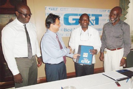 L-R – GT&T’s Chief Financial Officer Justin Nedd, GT&T CEO Mr. R.K Sharma, UG’s Vice Chancellor Prof. Jacob  Opadeyi and UG’s Registrar Mr. Vincent Alexander at yesterday’s signing.  (GT&T photo)