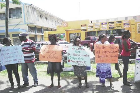 Protesters yesterday along the Main Street Avenue opposite the Ministry of Culture, Youth and Sport, calling for an independent investigation of recent reports of sexual abuse of New Opportunity Corps (NOC) inmates. 