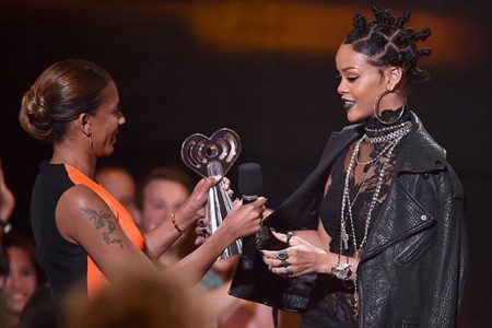 Rihanna accepts the Best Fan Army award onstage from singer Mel B during the 2014 iHeartRadio Music Awards held at The Shrine Auditorium on May 1, 2014 in Los Angeles, California. (Kevin Winter/Getty Images)
