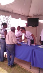 A US Embassy staffer interacting with a man   