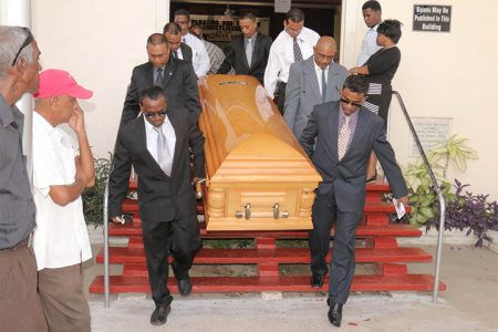 Pall bearers exit the Bethel Gospel Hall with Ronald Webster’s casket after the funeral service yesterday.
