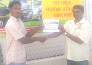 Sales Representative of Trans Pacific Amar Ramsook (right) presents the cheque to Benedict Prince.  