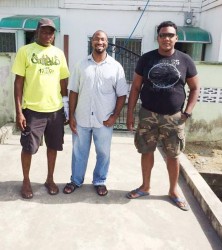 From left: Contractor  Malcolm Andrews of Vision Construction Company, which would be effecting repairs to the building, employee of the US Embassy Michael Fraser and GWMO member Hector Broomes stand in front of the building after Sunday’s clean up. 