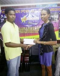 Ms. Kesheka Washington of Star Party Rental hands over the cheque to Bendict Prince of Quest International. 