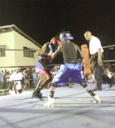 Punches being thrown in the action packed bout involving Junior Henry (left) and Tefon Green on Saturday night at the East Ruimveldt Community Centre Ground. 