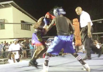 Punches being thrown in the action packed bout involving Junior Henry (left) and Tefon Green on Saturday night at the East Ruimveldt Community Centre Ground.