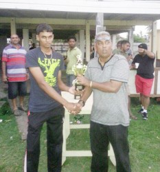  Shameer Sahib, vice chairman of the Enmore Cricket Club hands over the second prize to Lusignan’s captain.                 