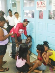 Family members weeping outside of the Georgetown Hospital’s emergency unit after learning that Lloyd Hazel was dead. 