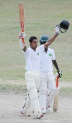 Opener Tagenarine Chanderpaul celebrates his unbeaten hundred yesterday at the GCC ground.