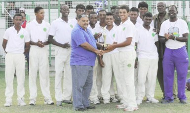 Tagenarine Chanderpaul collects the man-of-the-match trophy from president of the Guyana Cricket Board (GCB) Drubahadur. 