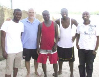 Lawrence Lachmansingh (second from left) and Horatio Nii Dodoo (centre) standing on the beach with the others. The river is in the background. (photo: Francis Quamina Farrier via Guyanese Online)