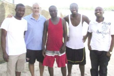 Lawrence Lachmansingh (second from left) and Horatio Nii Dodoo (centre) standing on the beach with the others. The river is in the background. (photo: Francis Quamina Farrier via Guyanese Online)