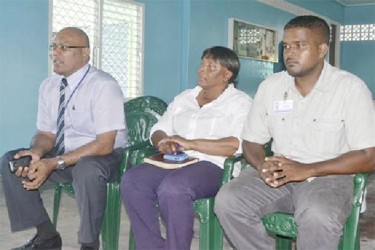 From Left, Chief Executive Officer of the Guyana Power and Light Company, Bharat Dindyal, Project Engineer of the Mahaicony Substation, Gail Best and Area Engineer, Onverwagt, Subash Mipal during the outreach meeting with residents. (GINA photo)