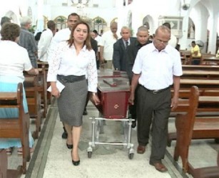 Foreign Affairs Minister Carolyn Rodrigues-Birkett (left) and John Rodrigues (brother of the deceased) along with others bear the casket of  the late Basil Rodrigues out  of the Brickdam Cathedral  (GINA photo) 