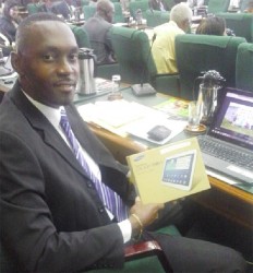 APNU Member of Parliament Christopher Jones holds the Samsung Tablet he received.