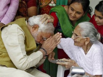 Hindu nationalist Narendra Modi, the prime ministerial candidate for India’s main opposition BJP, seeks blessings from his mother Heeraben at her residence in Gandhinagar in the western Indian state of Gujarat May 16, 2014. REUTERS/Amit Dave 