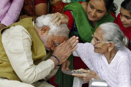 Hindu nationalist Narendra Modi, the prime ministerial candidate for India’s main opposition BJP, seeks blessings from his mother Heeraben at her residence in Gandhinagar in the western Indian state of Gujarat May 16, 2014. REUTERS/Amit Dave
