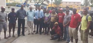 Minister of Sport, Dr. Frank Anthony (fifth from left) poses with the organizers and some of the cyclists competing in the Independence Three-Stage Road Race following the formal send off at his Main Street ministry yesterday. 