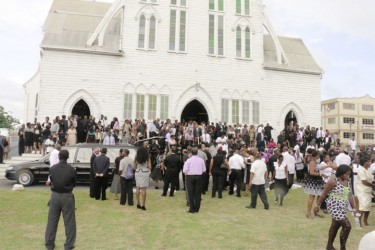Some of the hundreds of people who turned out to pay their last respects to Bank of Guyana Governor Lawrence Williams, standing outside the St George’s Cathedral after his funeral service yesterday. (See Page 15) (Photo by Arian Browne)
