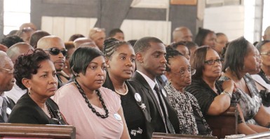 (From left) Lawrence Williams’s widow Valerie, his children and relatives at his funeral service yesterday at the St George’s Cathedral. (Photo by Arian Browne) 