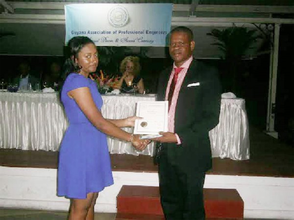 Nkechi Mc Pherson receiving the Phillip Allsopp award from President of the Guyana Association of Professional Engineers Kwame Pindar at the association’s 46th anniversary dinner on Saturday evening at the Georgetown Club.