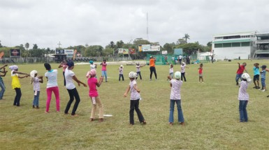 Inga Henry working with some of the players during a softball training session