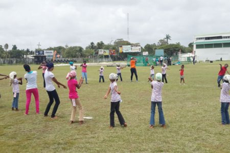 Inga Henry working with some of the players during a softball training session