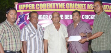 Mr. Shamnarine Narine proprietor of GUYTRAC hands over the sponsorship cheque to UCCA president Mr. Dennis De Andrade. Also in photo are Mr. H.N. Sugrim and other executives of the UCCA.