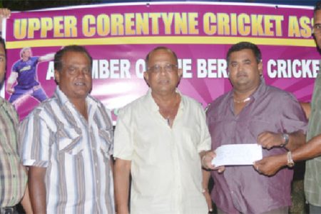 Mr. Shamnarine Narine proprietor of GUYTRAC hands over the sponsorship cheque to UCCA president Mr. Dennis De Andrade. Also in photo are Mr. H.N. Sugrim and other executives of the UCCA.